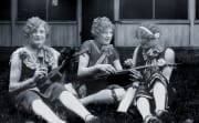 3 women posing at camp with their musical instruments