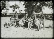 4 army men posing on motorcycles