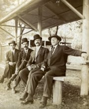 A group of men sitting on a bench