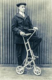 Man with antique bicycle